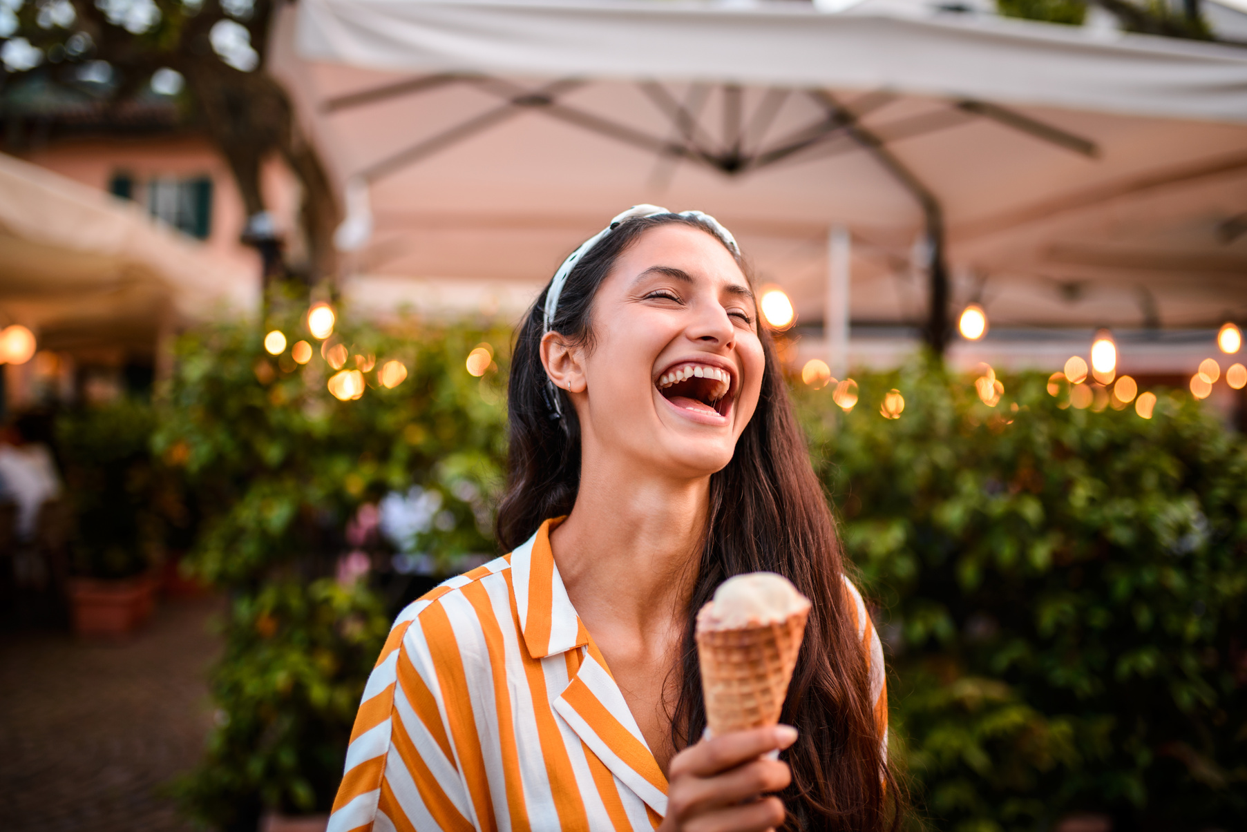 Laughing woman eating ice cream.